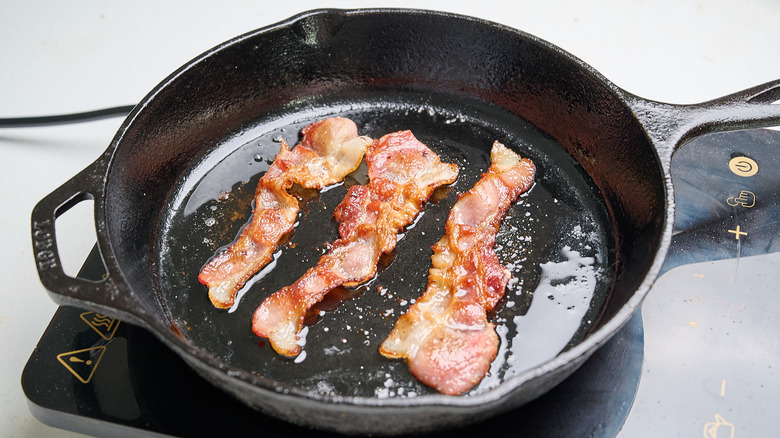 cooking bacon in a skillet