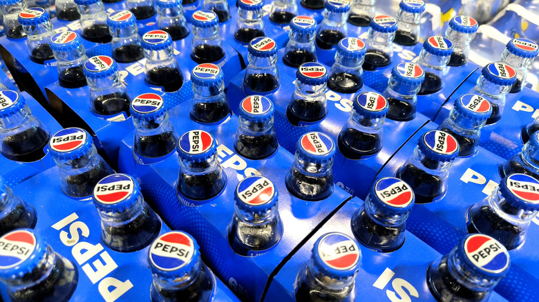 Pepsi glass bottles in blue cardboard carriers