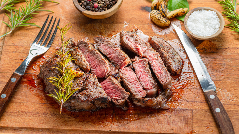Sliced ribeye cap steak with salt and herbs